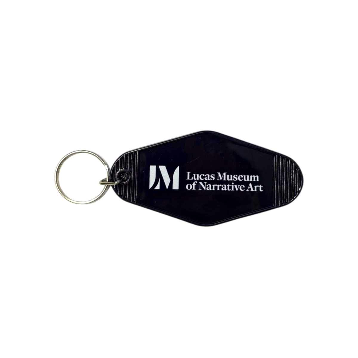 A black plastic keychain with a silver metal split ring, featuring the white printed logo and text 'Lucas Museum of Narrative Art'.