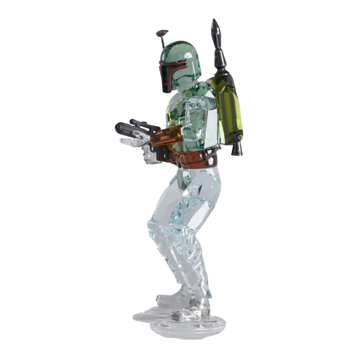 A clear faceted Swarovski crystal figurine of Boba Fett, holding a blaster, standing on a transparent base against a plain white background.