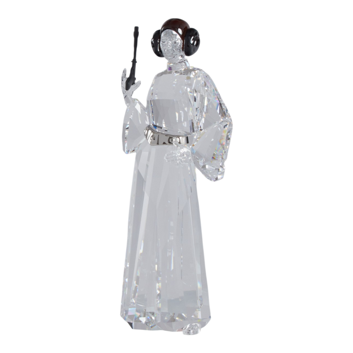 A clear faceted Swarovski crystal figurine of Princess Leia holding a black lacquered metal gun, standing on a transparent base against a plain white background.