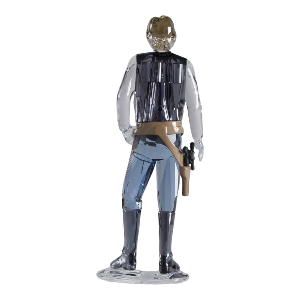 A clear faceted Swarovski crystal figurine of Hans Solo standing on a transparent base against a plain white background.