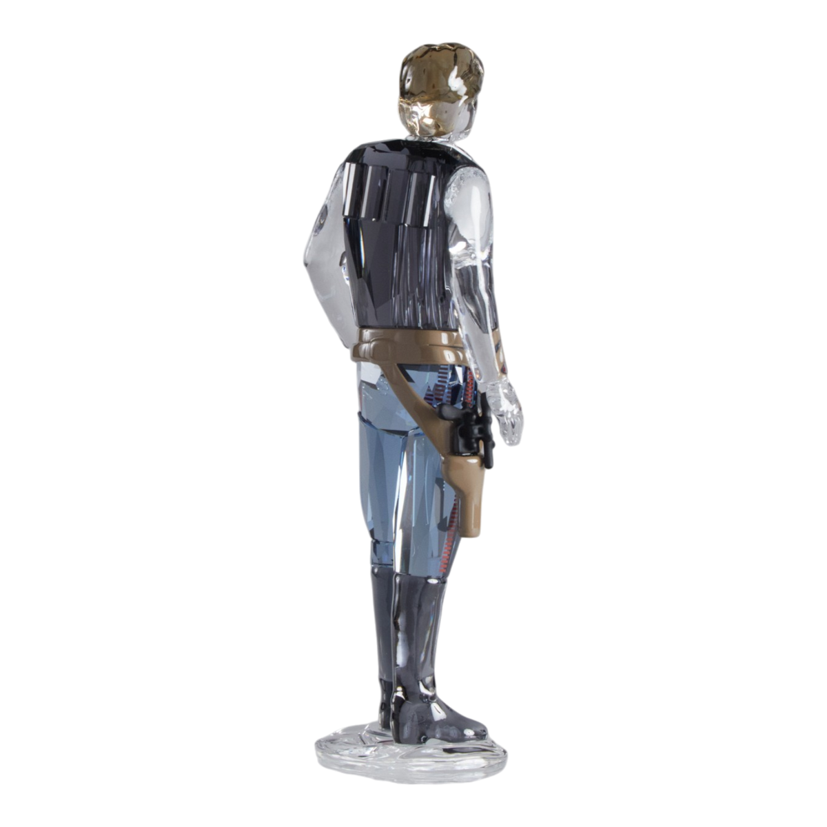 A clear faceted Swarovski crystal figurine of Hans Solo standing on a transparent base against a plain white background.
