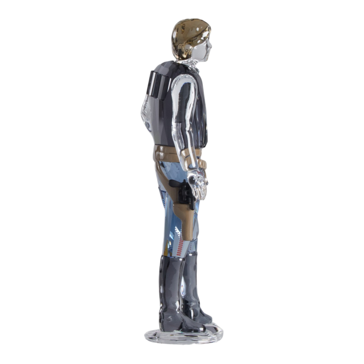 A clear faceted Swarovski crystal figurine of Hans Solo standing on a transparent base against a plain white background.