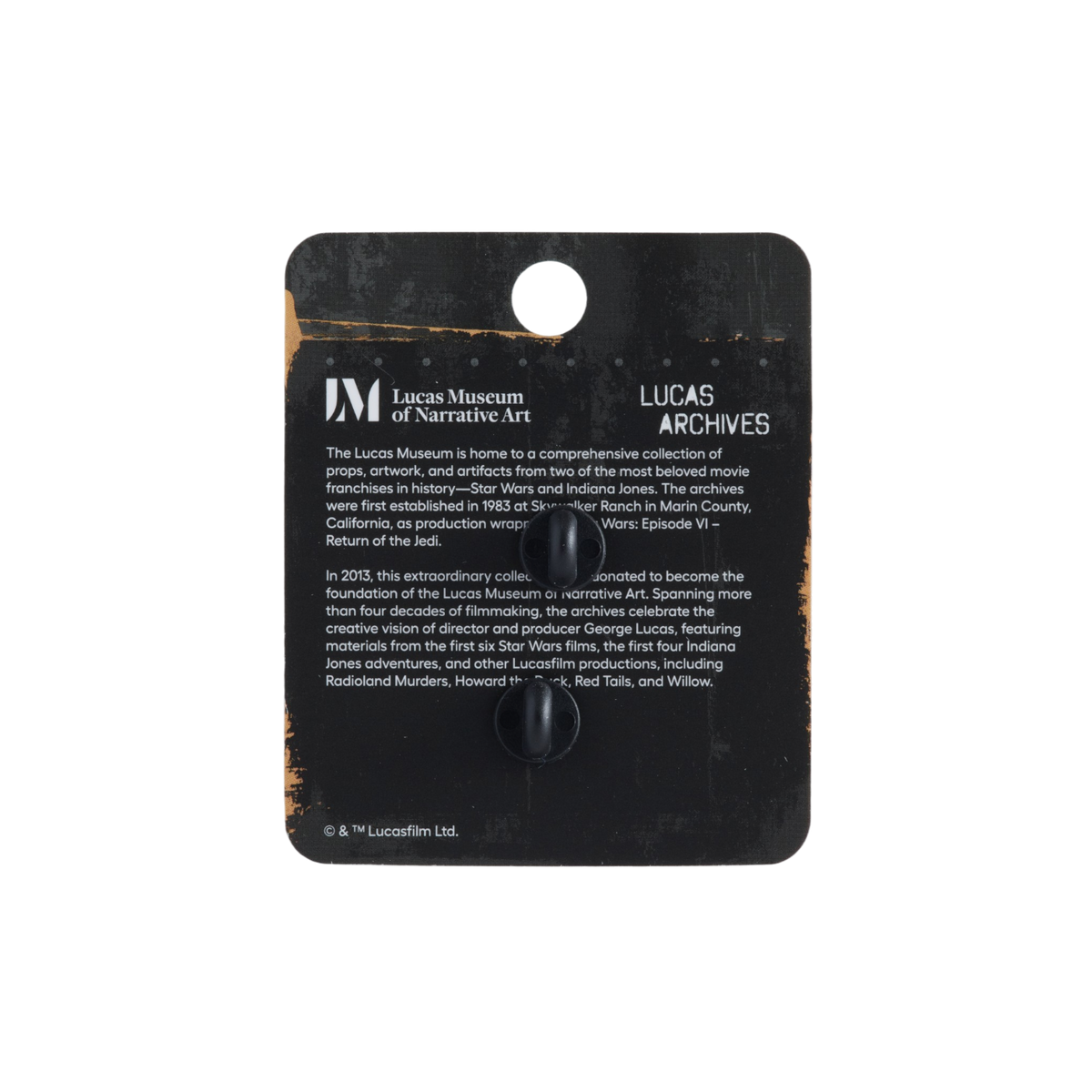 Lucas Archives display card from Lucas Museum of Narrative Art, featuring a black card with printed text and a small black knob in the center, photographed against a plain white background.