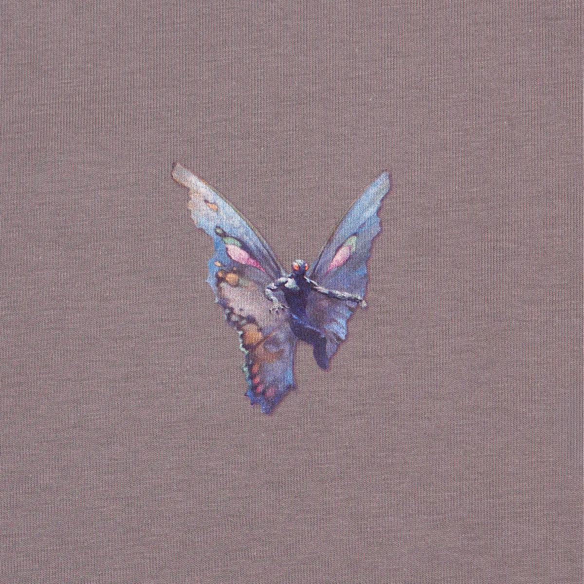 A Mothman graphic in shades of blue, purple, pink, and brown, centered on a textured taupe fabric background.