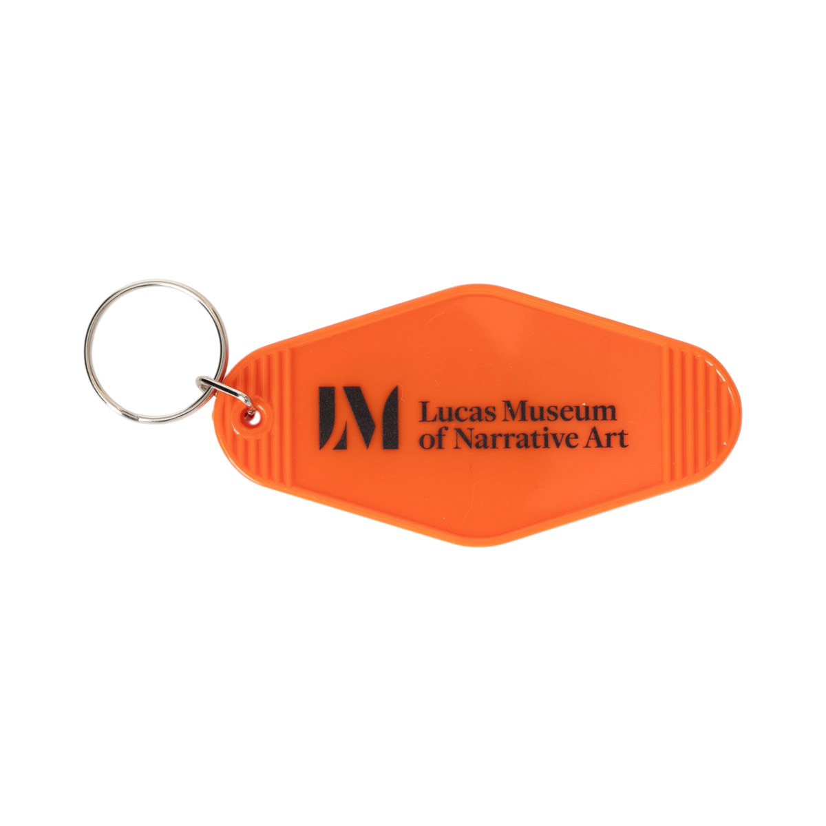 LMNA orange retro motel key tag (3.5" x 1.8") with a silver-tone split ring and bold black text reading "No Risk, No Story" on the front, and the Lucas Museum of Narrative Art name and logo on the back.