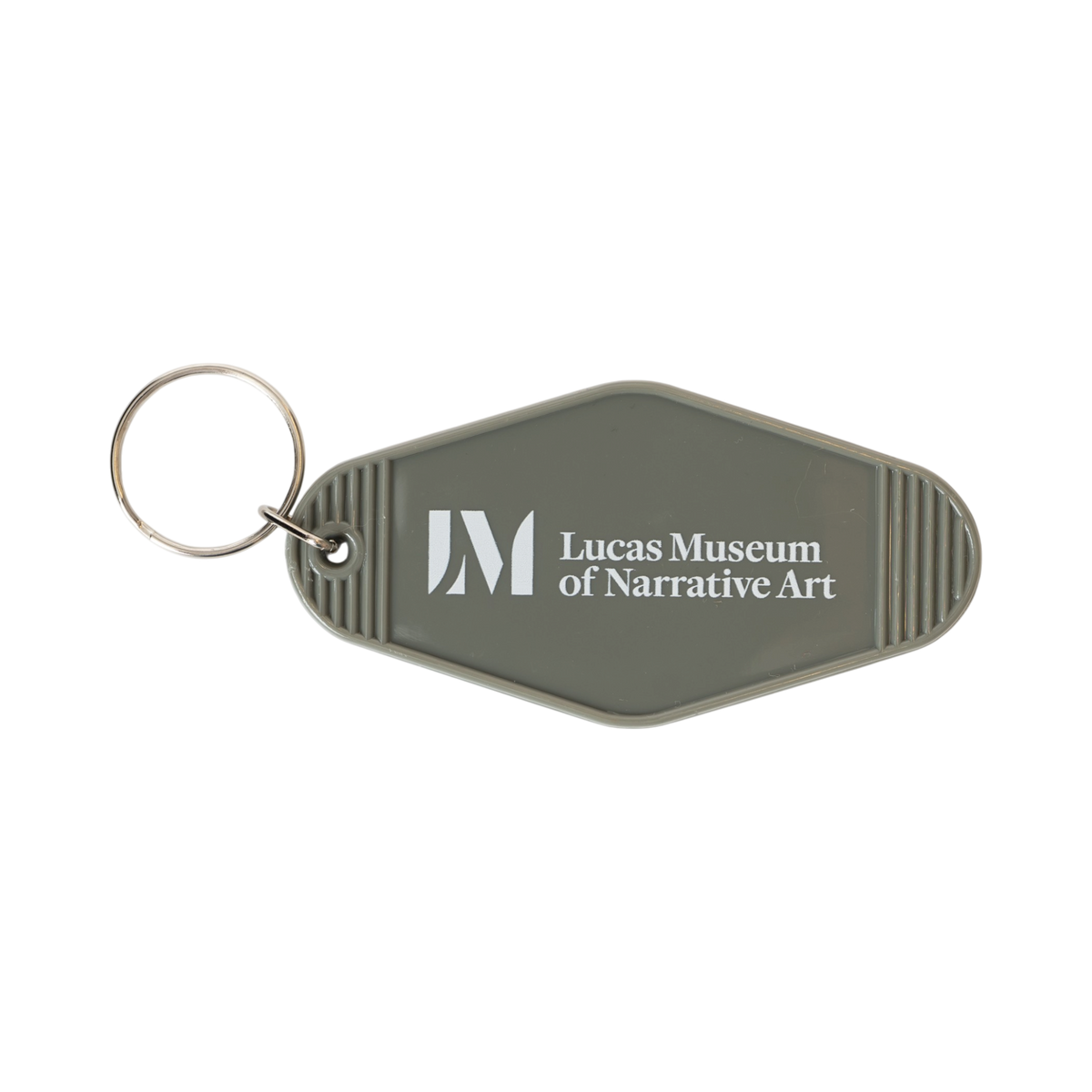  3.5 in x 1.8 in retro motel key tag in khaki and navy with text that reads, "Master of Both Worlds," on the front and has Lucas Museum of Narrative Art's name and logo on the back.