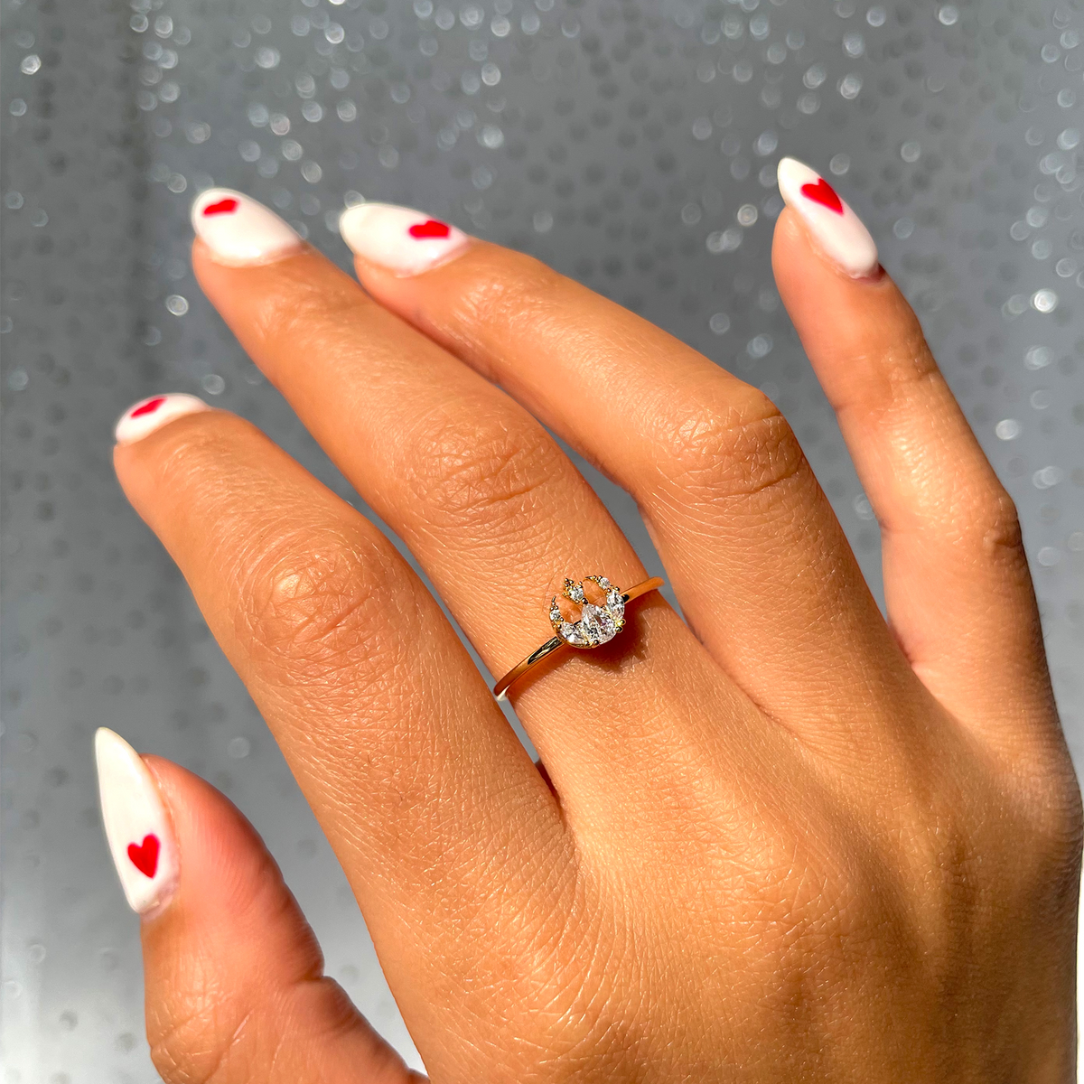 Gold-tone Rebel Alliance insignia ring featuring a crystal-accented emblem with a pear-shaped center stone and marquise-cut clear crystals, displayed around a model's finger.