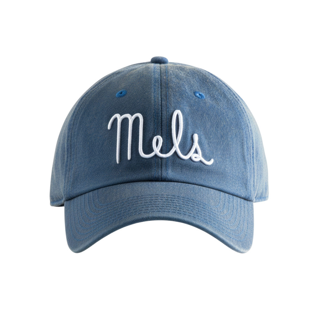 Cotton washed denim dad hat featuring white embroidered Mel's Diner emblem. 