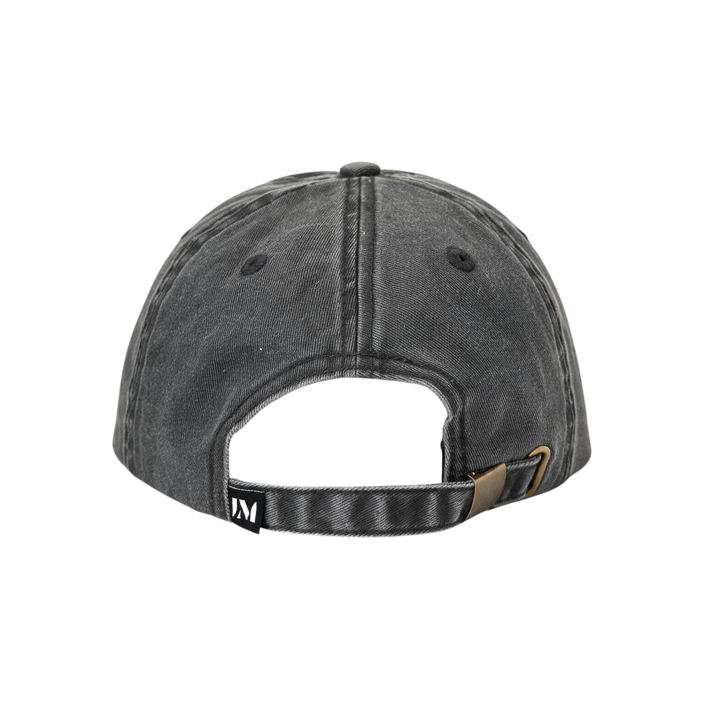 Back view of a dark gray washed baseball cap with an adjustable fabric strap and metal buckle closure, shown on a plain white background. "Main Character" is embroidered in white on the front.