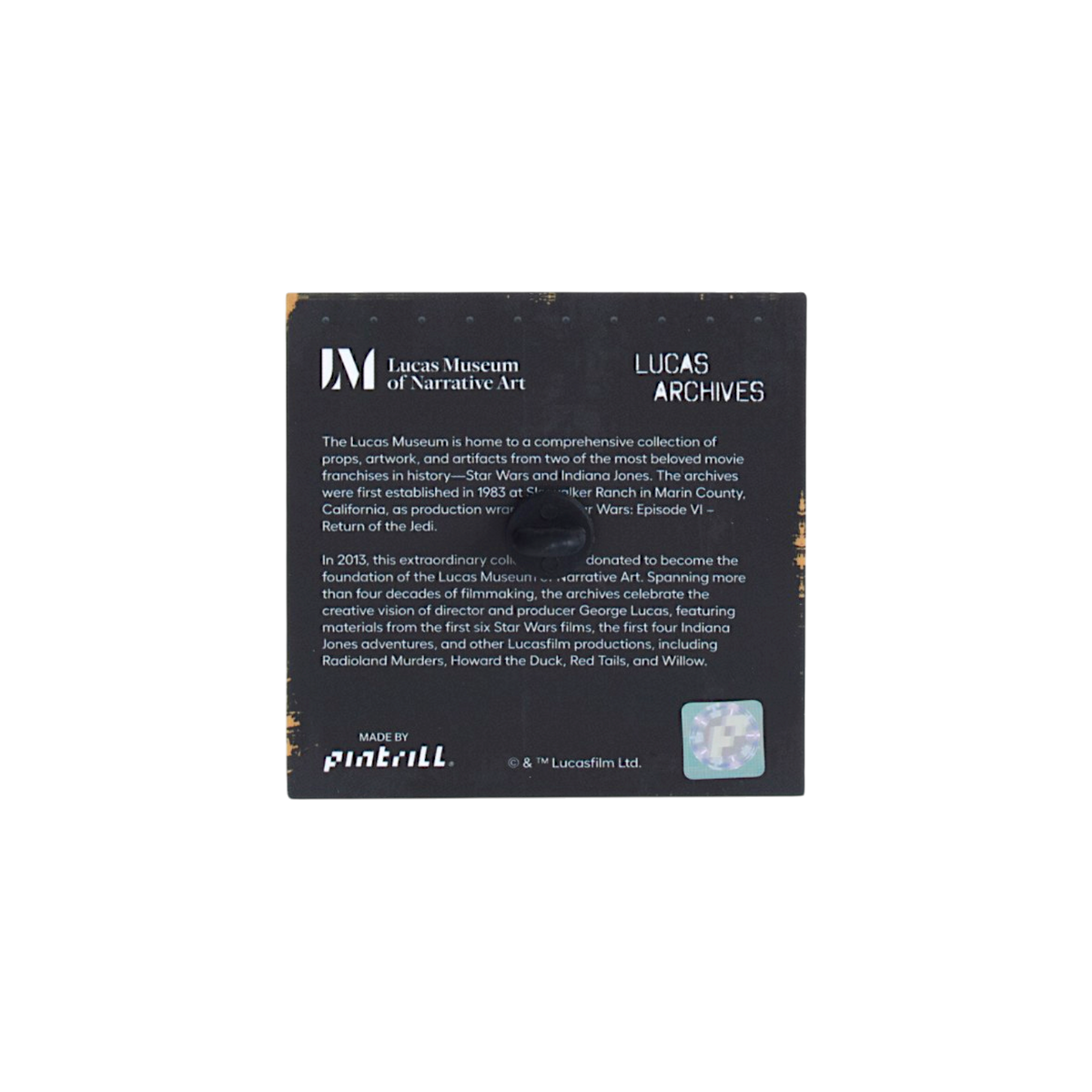 A square black product tag for Lucas Museum of Narrative Art's Lucas Archives pin, featuring white text, a small logo in the top-left corner, and a small clear window on the bottom right.
