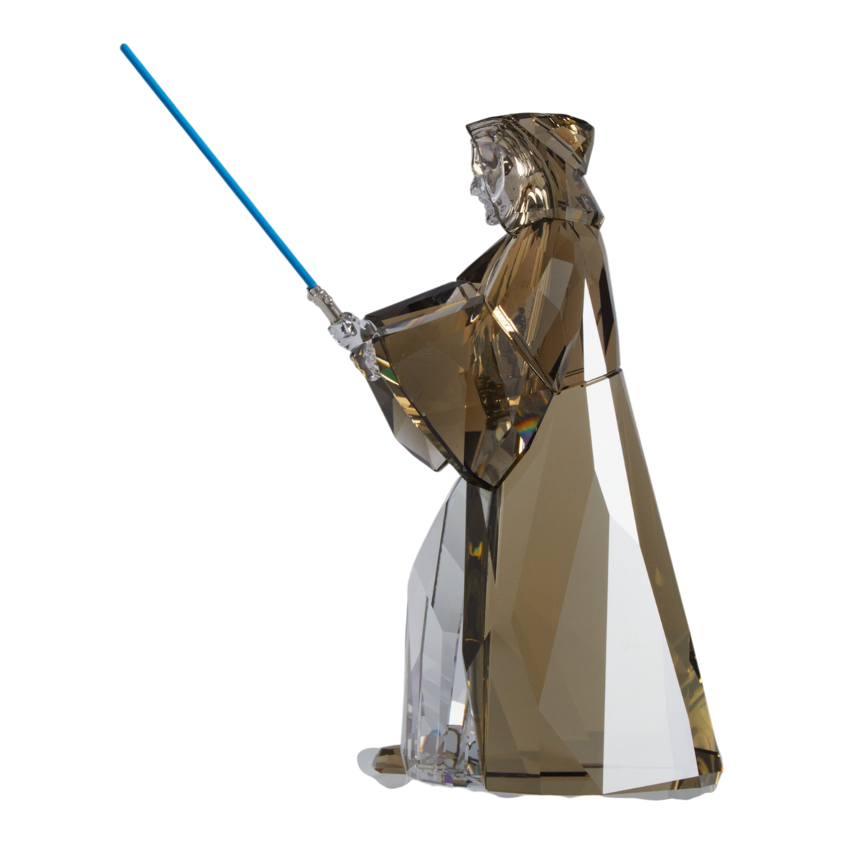A clear faceted Swarovski crystal figurine of Obi-Wan Kenobi holding a blue lightsaber, standing on a transparent base against a plain white background.