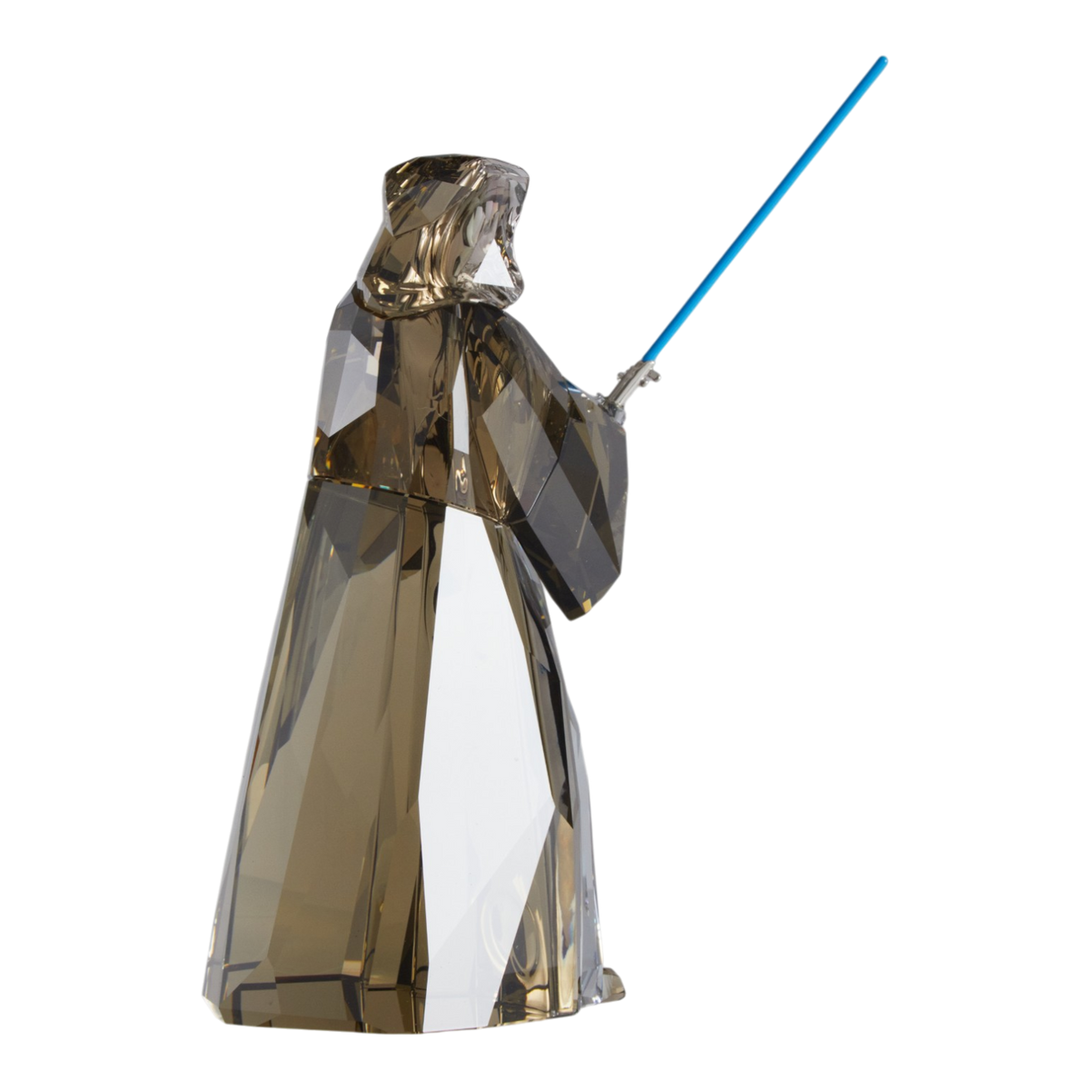 A clear faceted Swarovski crystal figurine of Obi-Wan Kenobi holding a blue lightsaber, standing on a transparent base against a plain white background.