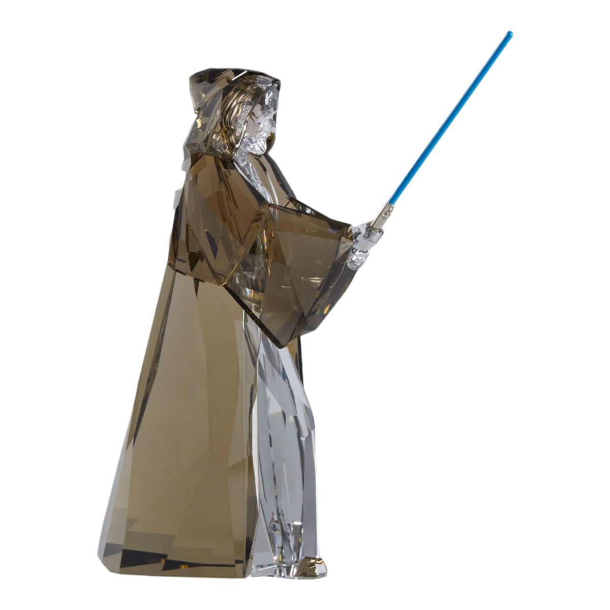 A clear faceted Swarovski crystal figurine of Obi-Wan Kenobi holding a blue lightsaber, standing on a transparent base against a plain white background.