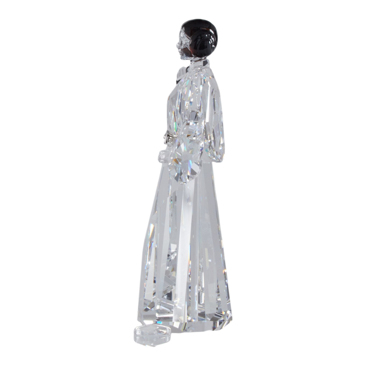 A clear faceted Swarovski crystal figurine of Princess Leia holding a black lacquered metal gun, standing on a transparent base against a plain white background.