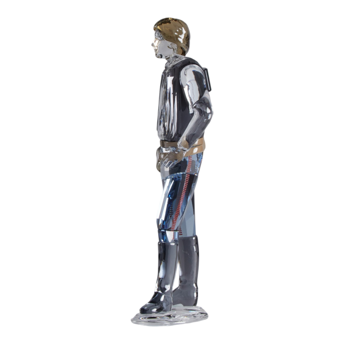 A clear faceted Swarovski crystal figurine of Hans Solo standing on a transparent base against a plain white background.