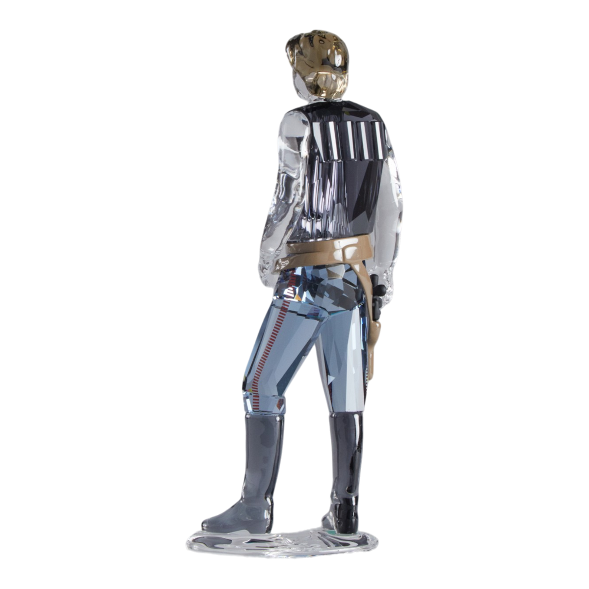 A clear faceted Swarovski crystal figurine of Hans Solo standing on a transparent base against a plain white background.