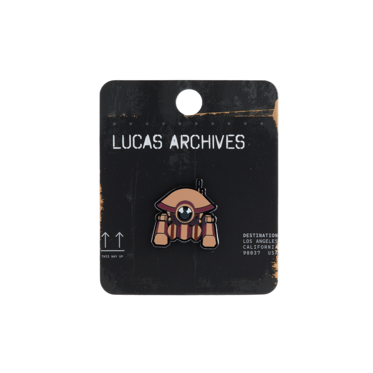 A Lucas Archive enamel pin of a D-O Droid standing on a black display card labeled 'LUCAS ARCHIVES'. The pin features a droid with tannish brown helmet and hat with burgundy and gold accents.