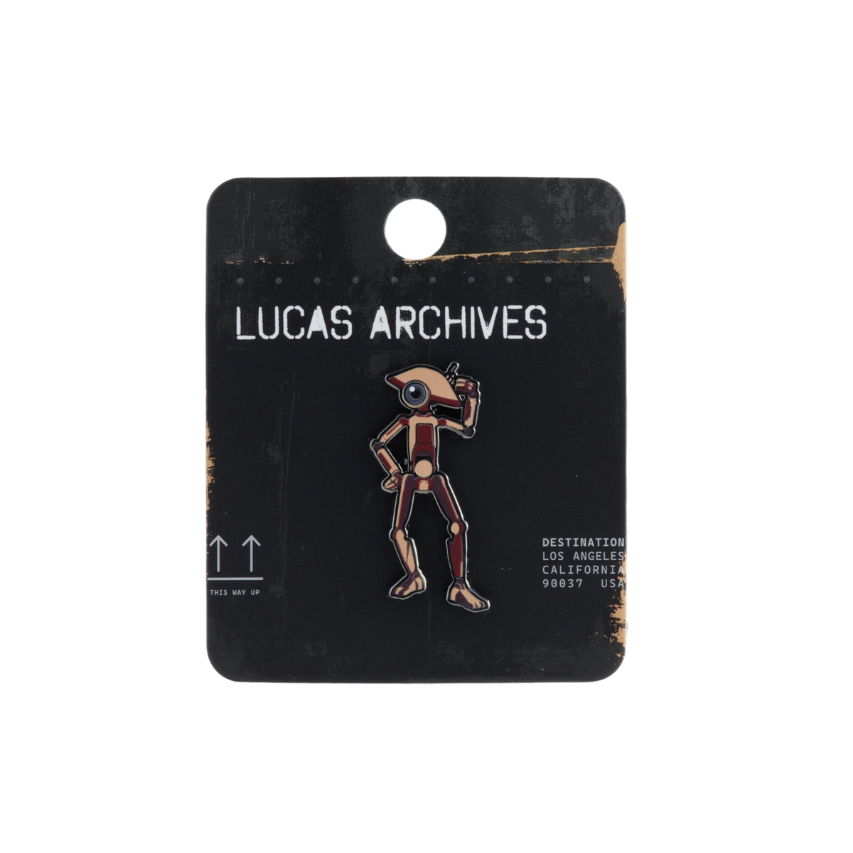 A Lucas Archive enamel pin of a D-O Droid standing on a black display card labeled 'LUCAS ARCHIVES'. The pin features a droid with tannish brown helmet and hat with burgundy and gold accents.