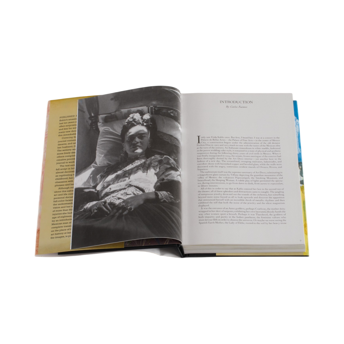 An open book showing a black-and-white historical photograph of Frida Kahlo on the left page and the introduction text on the right page, photographed on a clean white background.