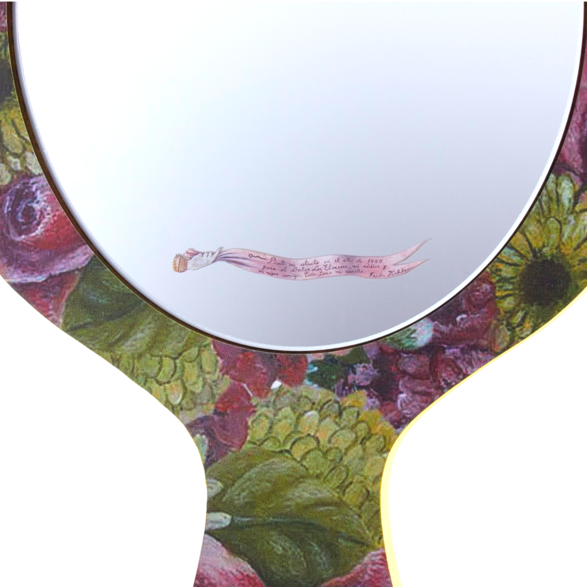 A decorative hand mirror with a floral and botanical painted border in shades of green, pink, red, and yellow, featuring a small pink ribbon illustration on the reflective surface.
