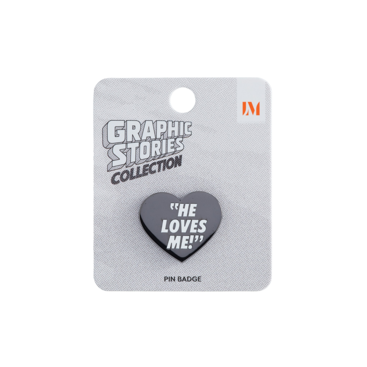 A gray heart-shaped pin badge with the text 'HE LOVES ME!' in white, mounted on a textured gray card labeled 'GRAPHIC STORIES COLLECTION' with an orange 'LM' logo.