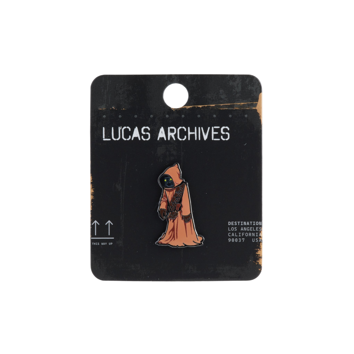 An enamel pin of an orange hooded JAWA figure from Star Wars, mounted on a black card labeled 'LUCAS ARCHIVES'