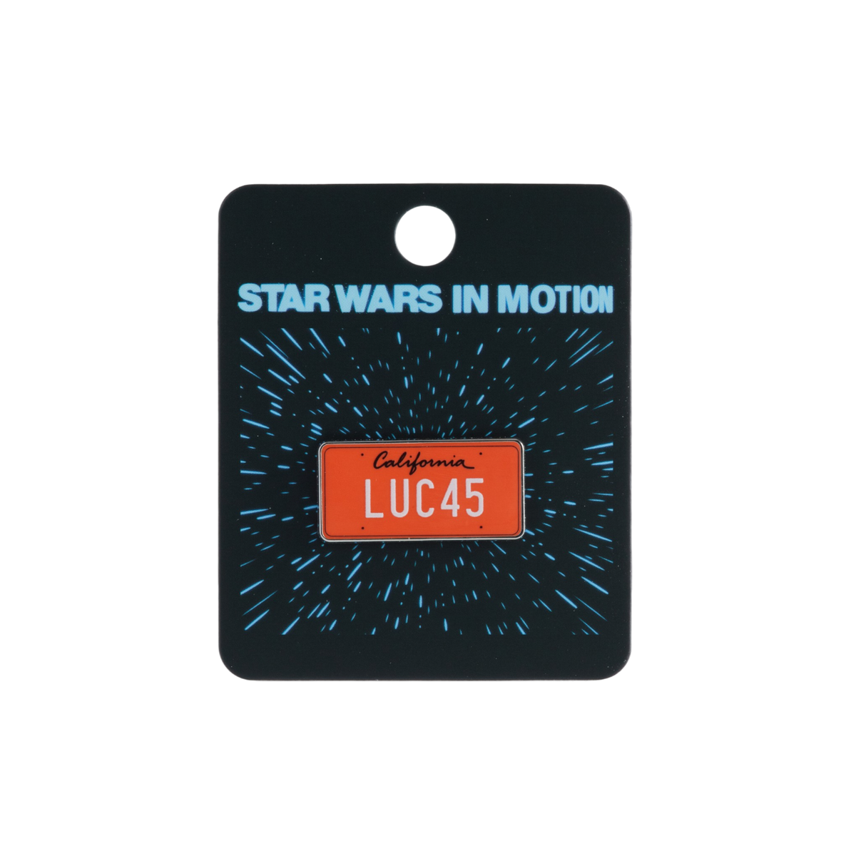 A Star Wars themed enamel pin shaped like a California license plate reading 'LUC45', mounted on a black backing card with 'STAR WARS IN MOTION' text and a blue starburst design.