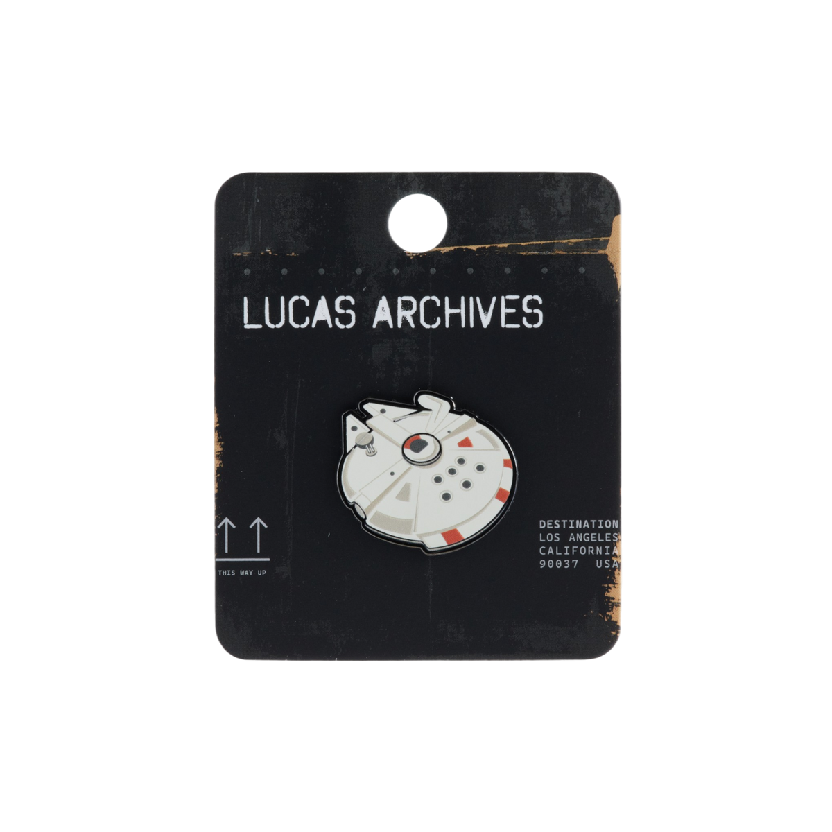 A Millennium Falcon enamel pin displayed on its black cardboard backing card, which features the text 'LUCAS ARCHIVES'.
