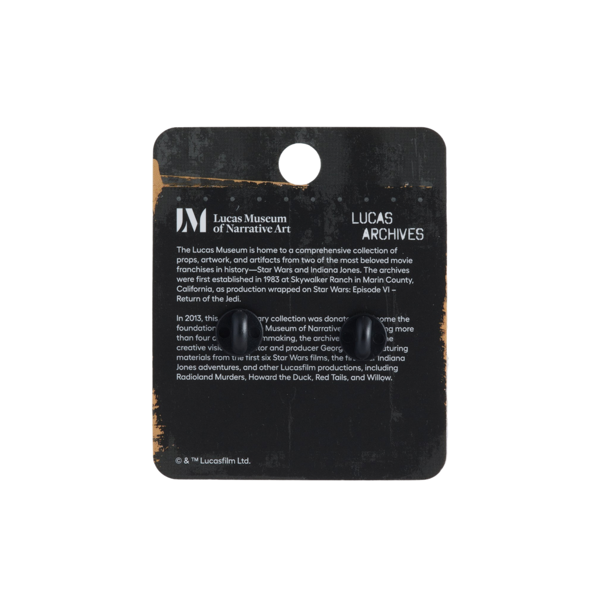 Lucas Museum of Narrative Art Lucas Archives collectible display card with two small black buttons attached, photographed against a plain white background.