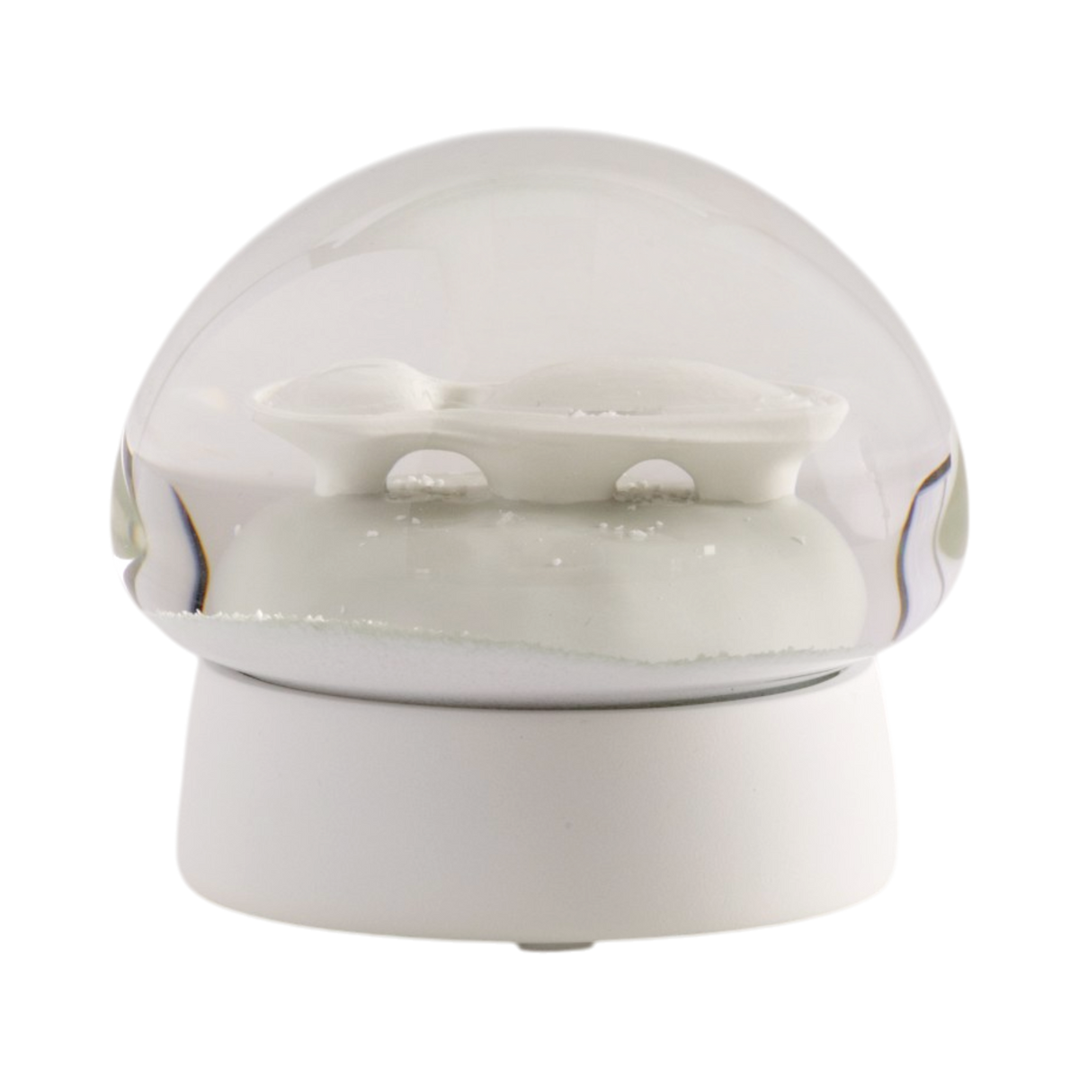 A white ceramic snow globe featuring the architectural structure of the Lucas Museum of Narrative Art inside a clear glass dome, set on a round white base against a plain white background.