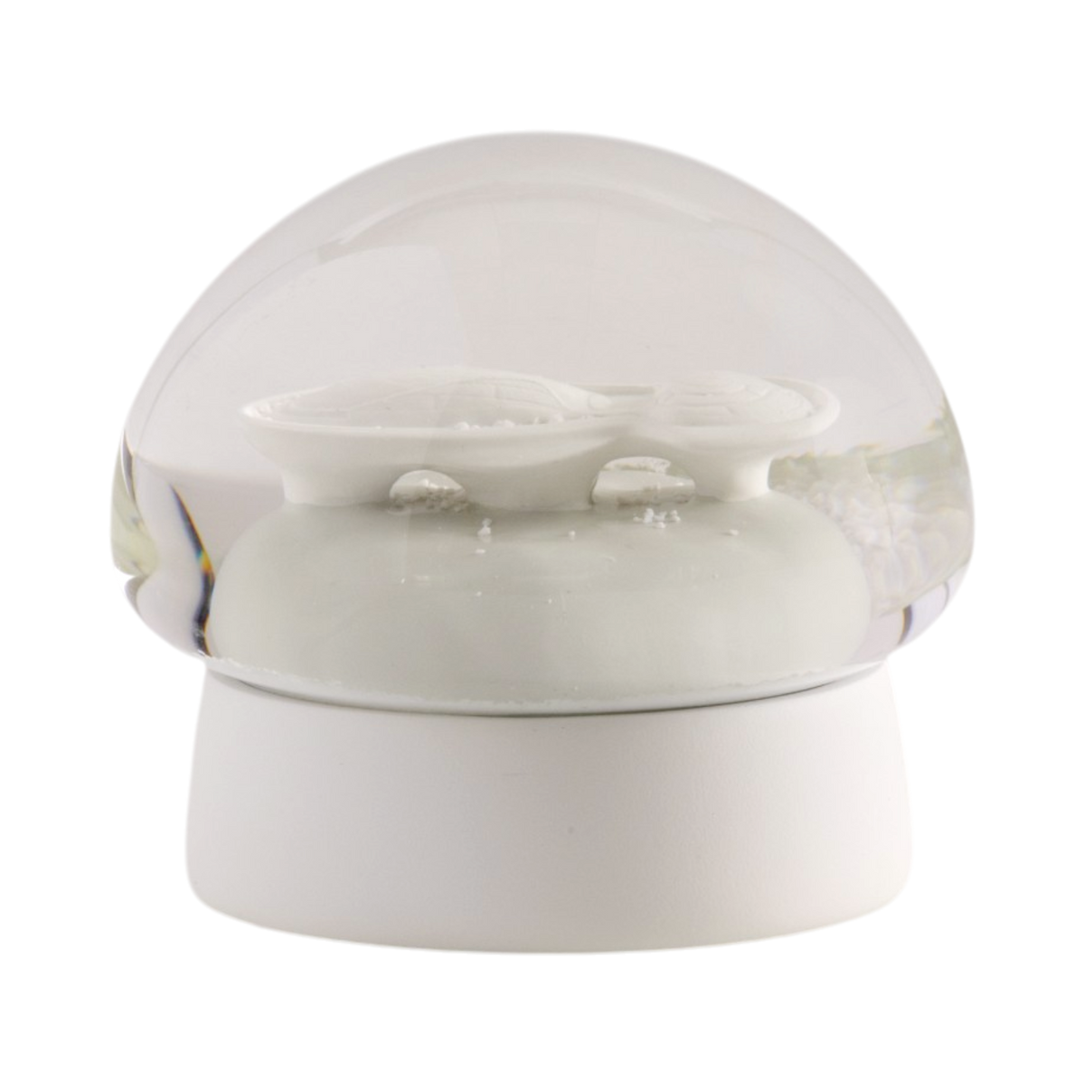A white ceramic snow globe featuring the architectural structure of the Lucas Museum of Narrative Art inside a clear glass dome, set on a round white base against a plain white background.