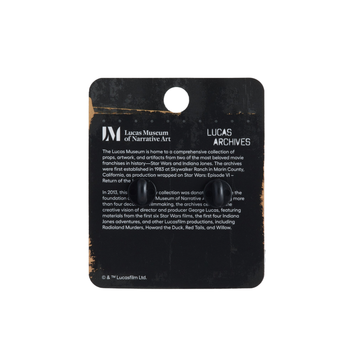 Lucas Museum of Narrative Art Lucas Archives collectible display card with two small black buttons attached, photographed against a plain white background.